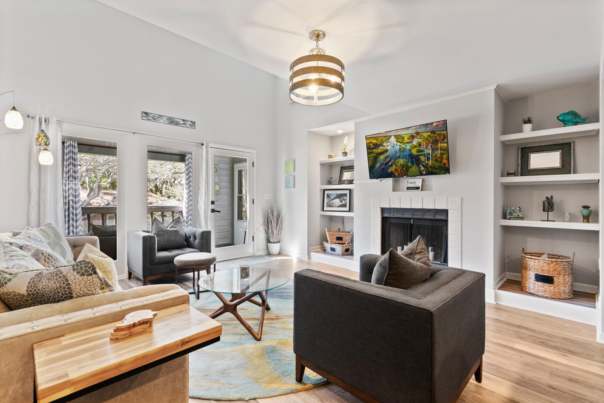 200 16th Street, Unit 202A St. Augustine, FL 32080 - Photo 15 of 39 a living room with furniture a fireplace and a flat screen tv