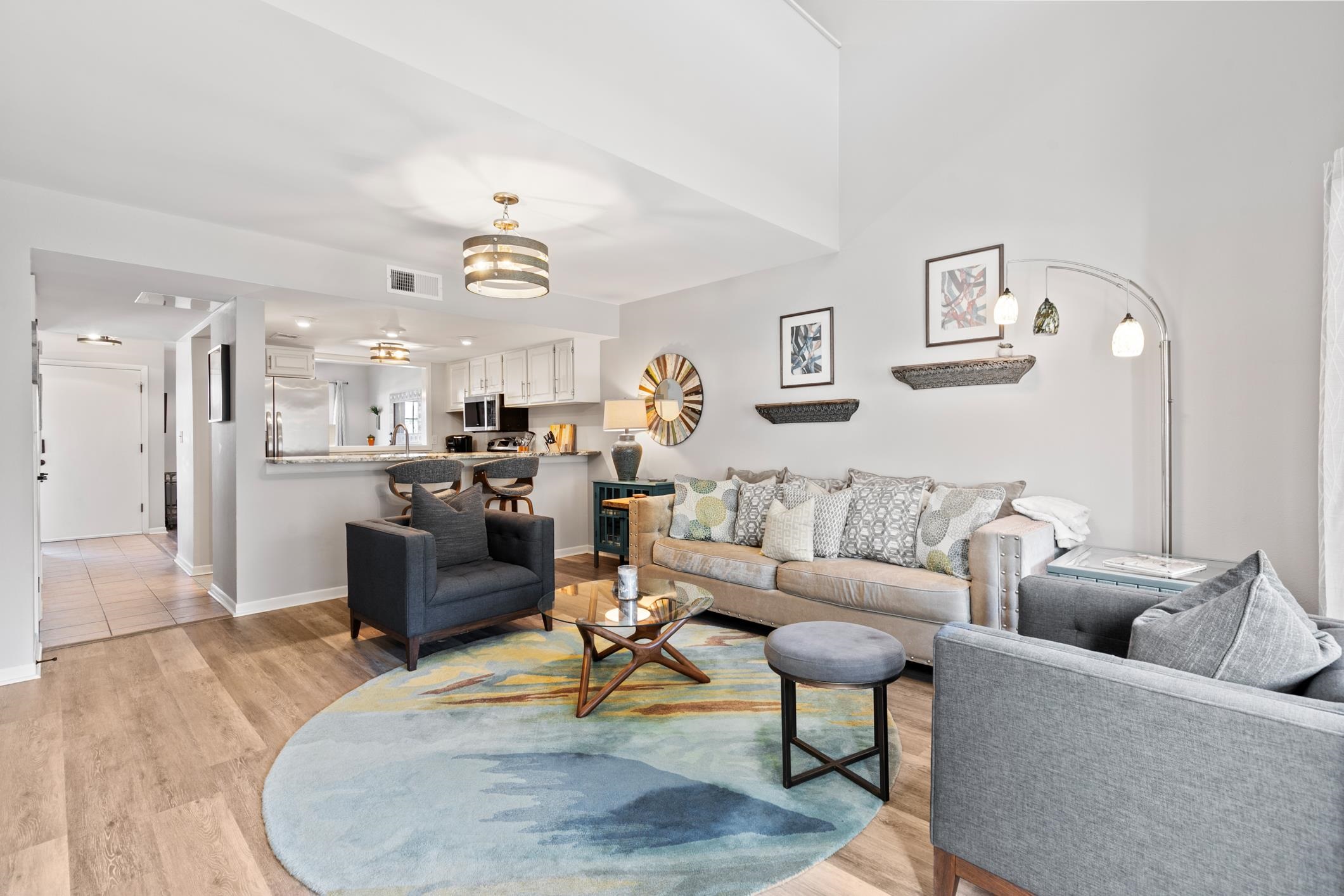 200 16th Street, Unit 202A St. Augustine, FL 32080 - Photo 16 of 39 a living room with furniture kitchen view and a chandelier