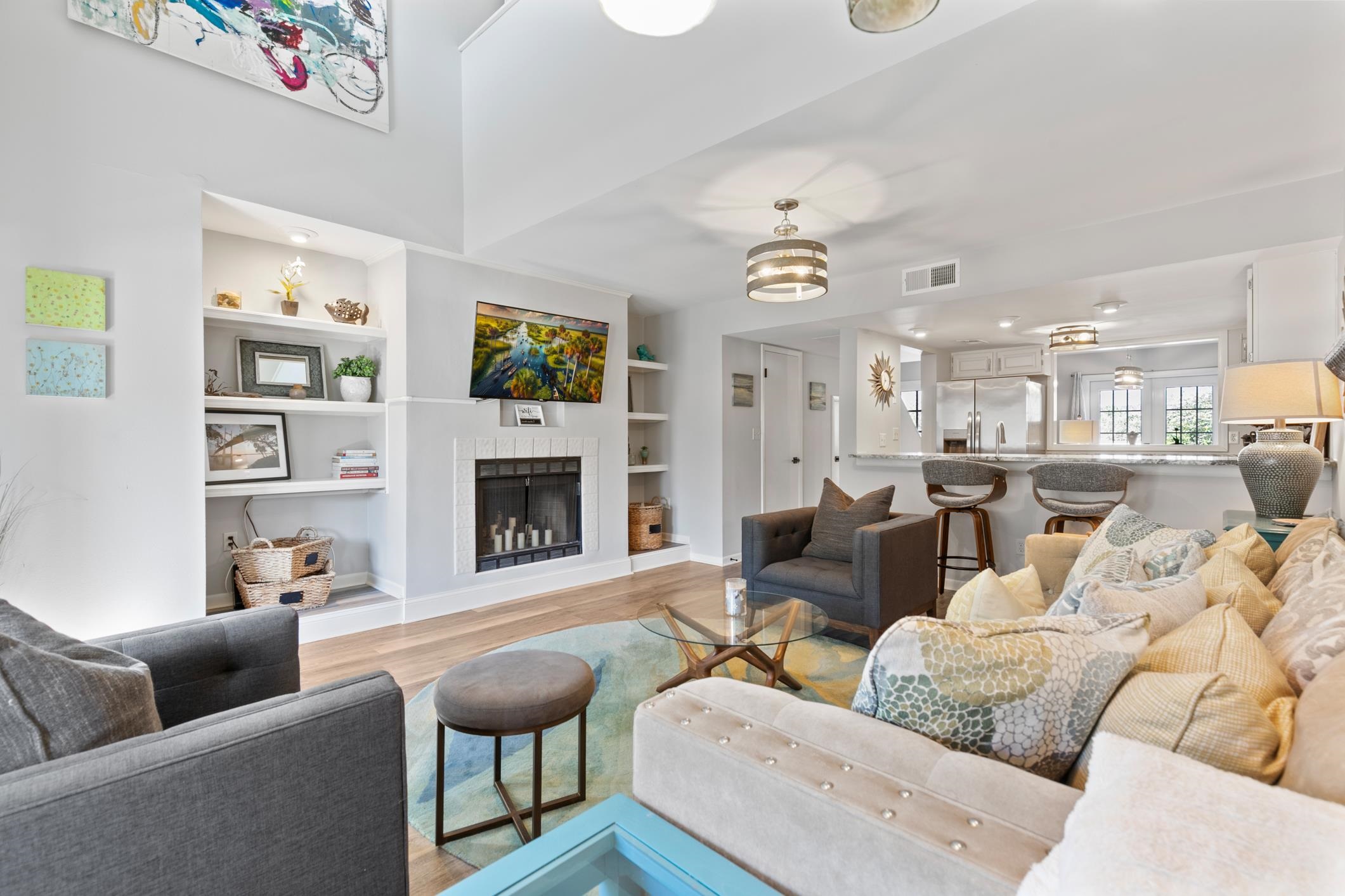 200 16th Street, Unit 202A St. Augustine, FL 32080 - Photo 17 of 39 a living room with furniture a flat screen tv and a fireplace