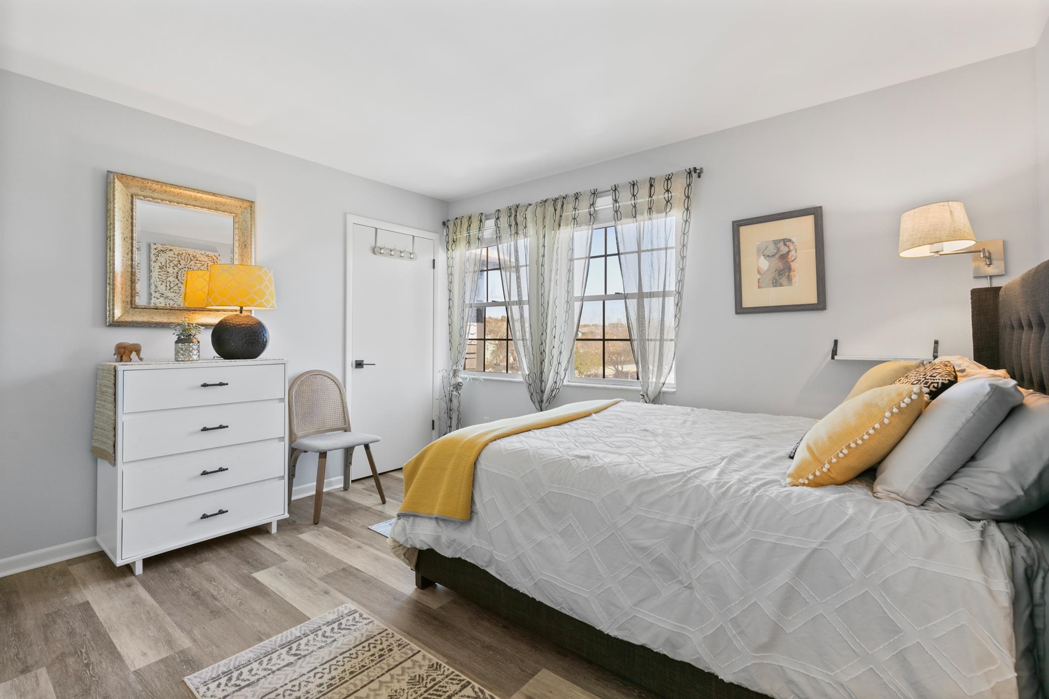 200 16th Street, Unit 202A St. Augustine, FL 32080 - Photo 21 of 39 a bedroom with a bed and wooden floor