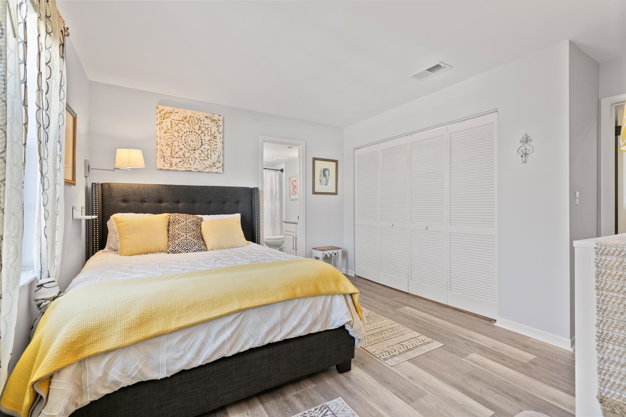 200 16th Street, Unit 202A St. Augustine, FL 32080 - Photo 22 of 39 a bedroom with a bed and painting on the wall