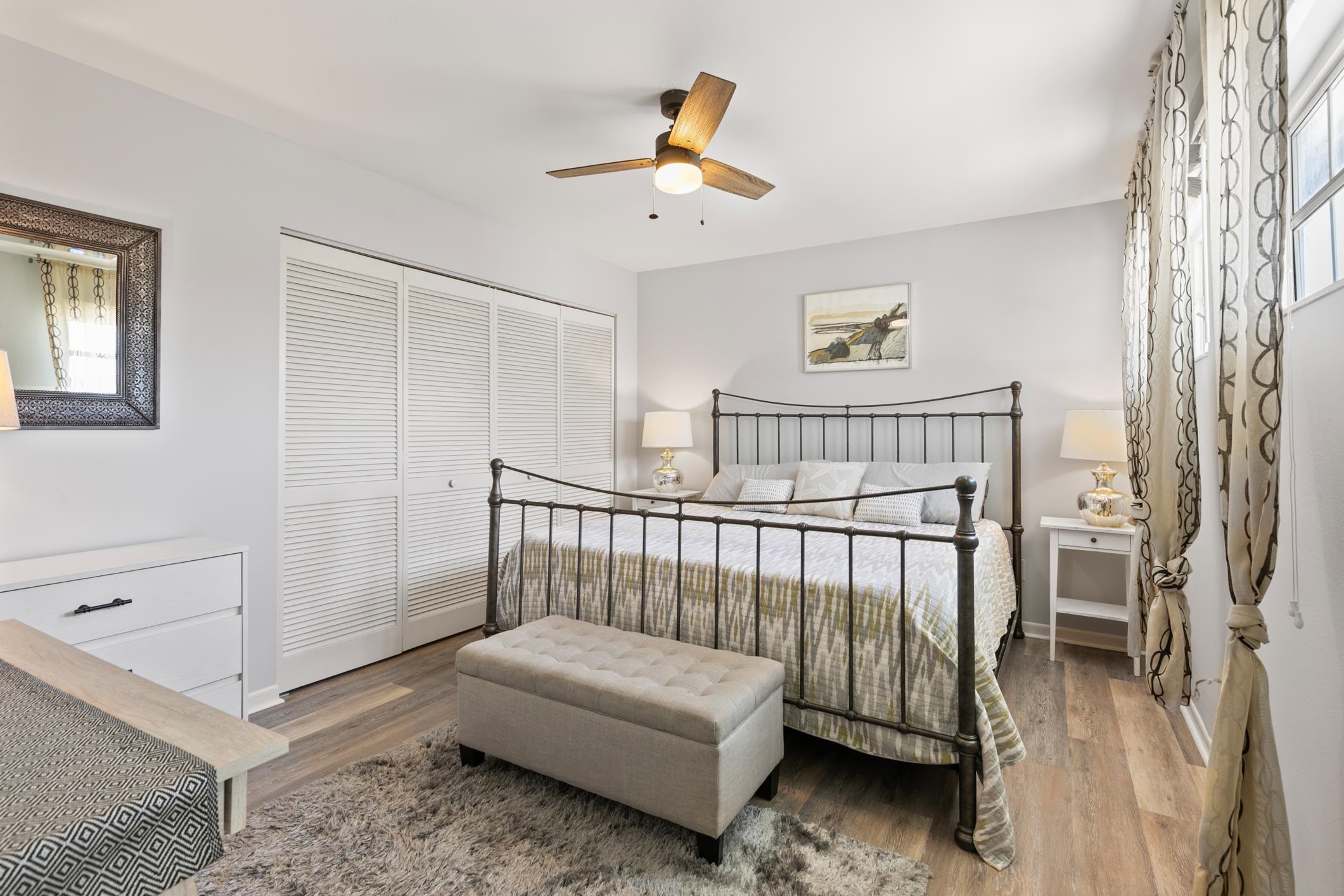 200 16th Street, Unit 202A St. Augustine, FL 32080 - Photo 26 of 39 a bedroom with a bed and a chandelier