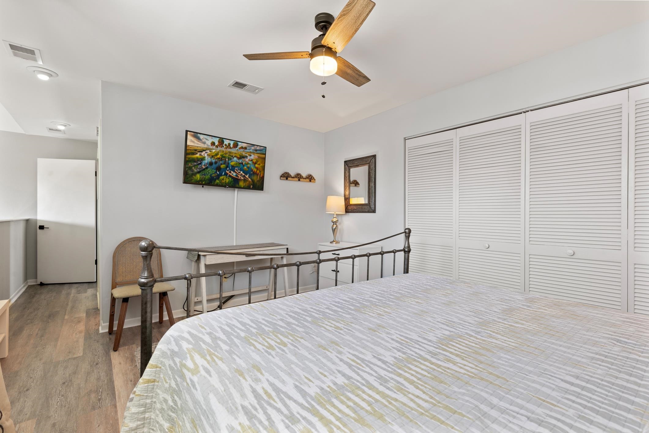 200 16th Street, Unit 202A St. Augustine, FL 32080 - Photo 28 of 39 a bedroom with a bed a chandelier and closet