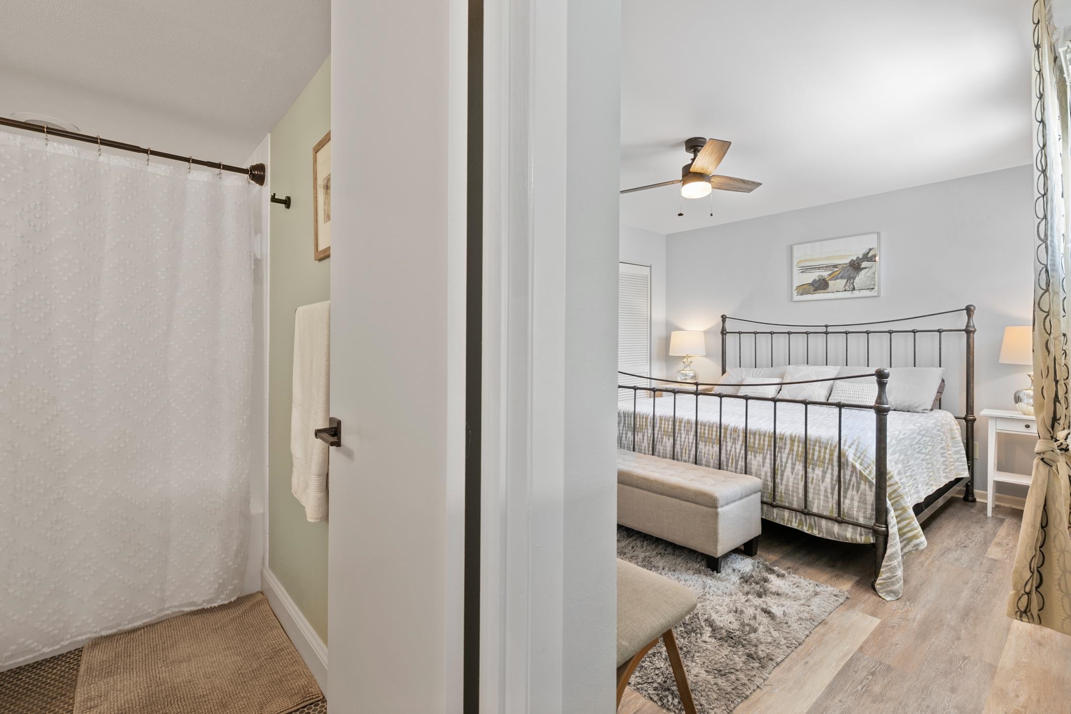 200 16th Street, Unit 202A St. Augustine, FL 32080 - Photo 30 of 39 a bedroom with a bed and a chandelier