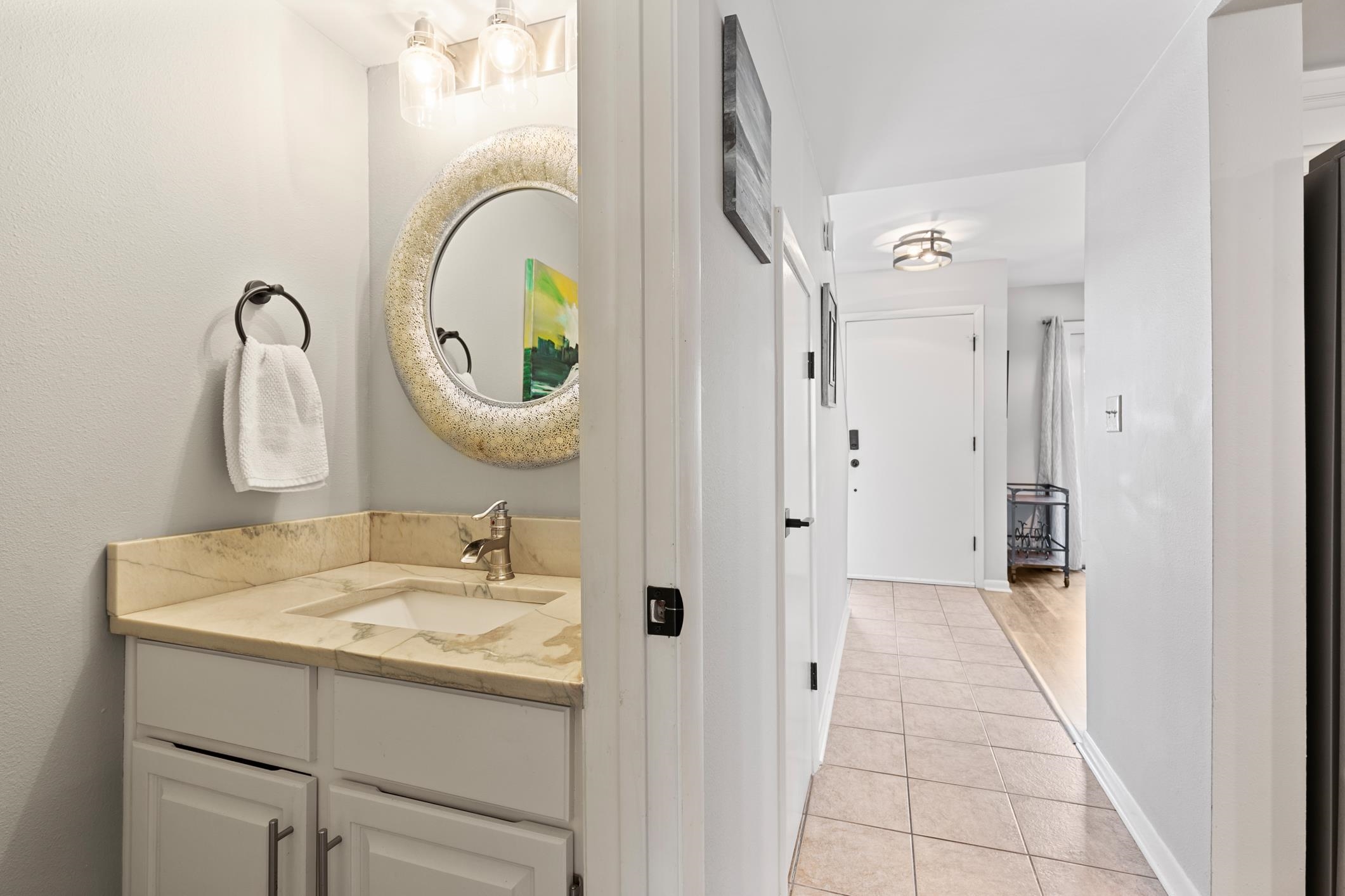 200 16th Street, Unit 202A St. Augustine, FL 32080 - Photo 33 of 39 a bathroom with a sink and a mirror