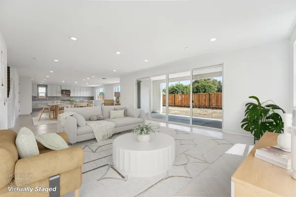 a living room with furniture plant and a window