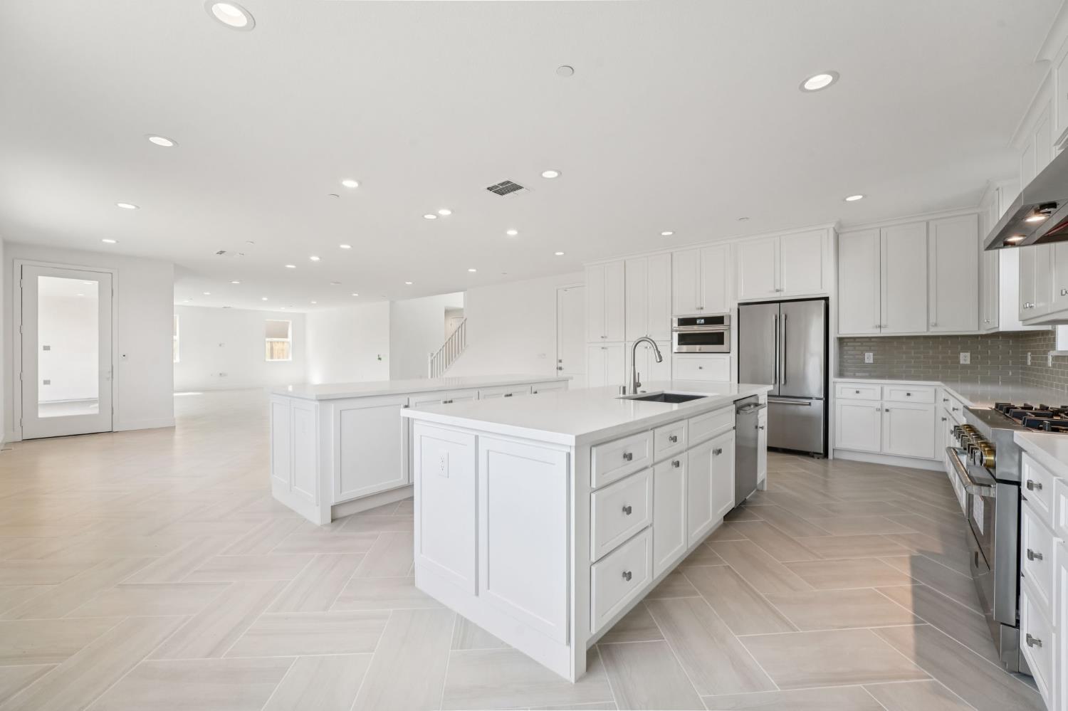 464 Trellis Way Brentwood, CA 94513 - Photo 13 of 22 a large kitchen with stainless steel appliances lots of white cabinets