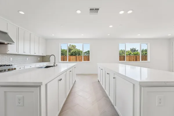 a kitchen with counter top space and windows