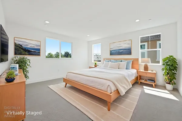 a bedroom with a bed potted plant on dresser and a window