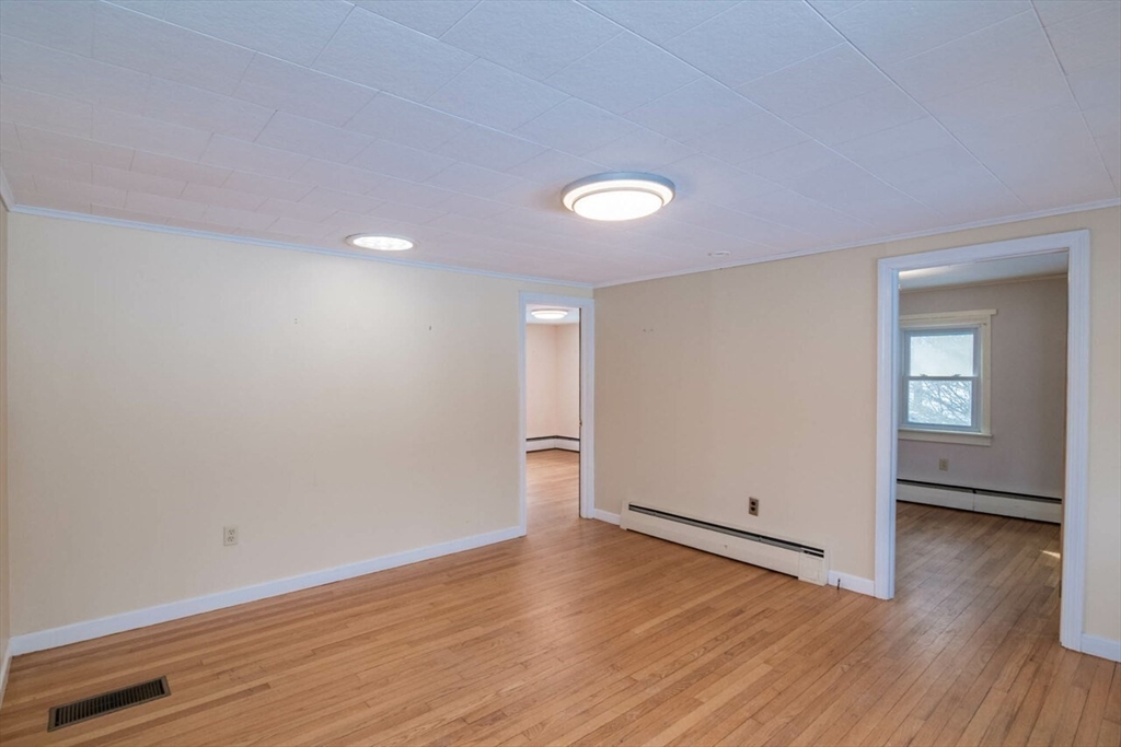 300 Main Road Westhampton, MA 01027 - Photo 5 of 35 an empty room with wooden floor and windows