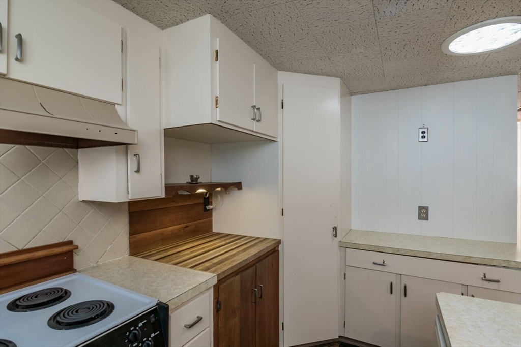 300 Main Road Westhampton, MA 01027 - Photo 10 of 35 a kitchen with white cabinets and stove