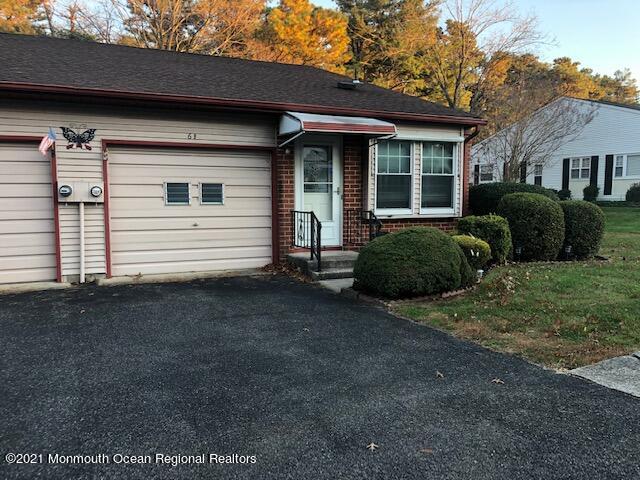 6 B Sunset Road, Unit 53 Whiting, NJ 08759 - Photo 1 of 8 a front view of a house with a yard