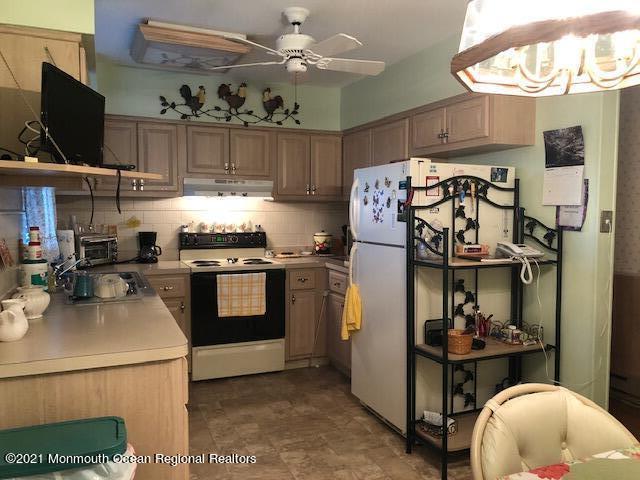 6 B Sunset Road, Unit 53 Whiting, NJ 08759 - Photo 3 of 8 a kitchen with stainless steel appliances granite countertop a stove and a refrigerator