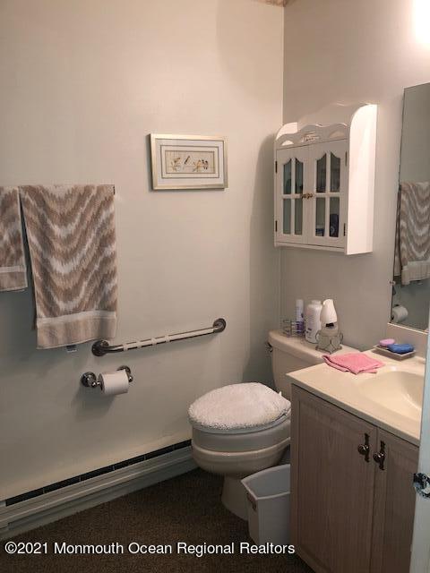 6 B Sunset Road, Unit 53 Whiting, NJ 08759 - Photo 6 of 8 a bathroom with a sink a toilet and a mirror