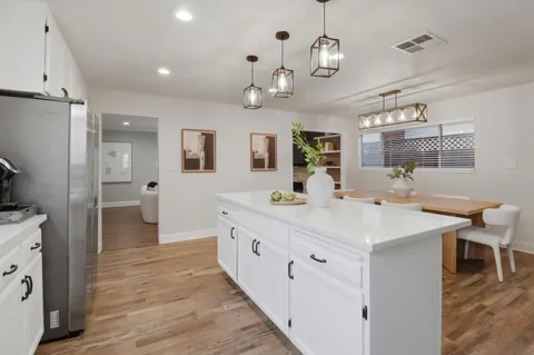 a view of a kitchen sink and wooden floor
