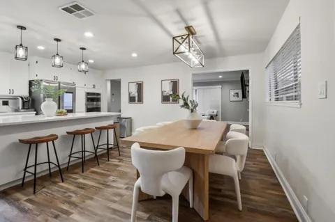 a large kitchen with a table and chairs