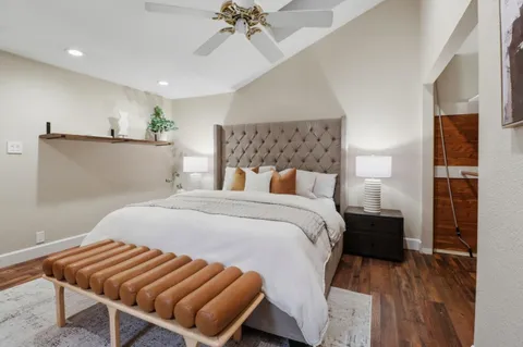 a bedroom with a bed and a flat screen tv