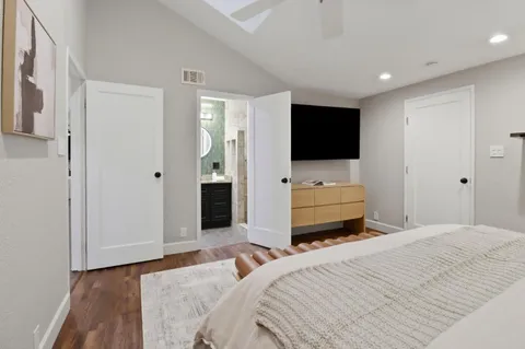 a bedroom with a bed and a flat screen tv