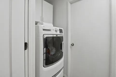 a view of a patio with table and chairs near a yard