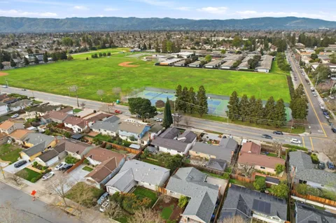 an aerial view of residential houses with outdoor space and river