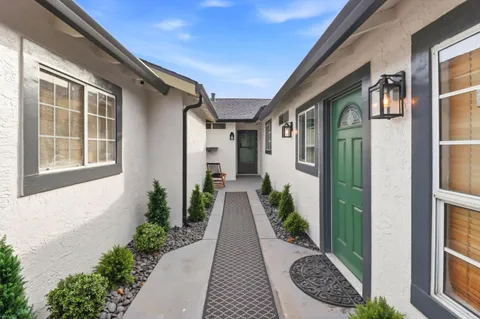 a view of a brick house with many windows