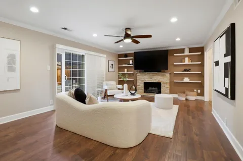 a living room with fireplace furniture and a flat screen tv