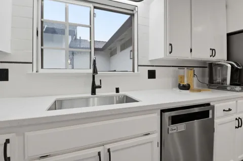a kitchen with a sink and cabinets