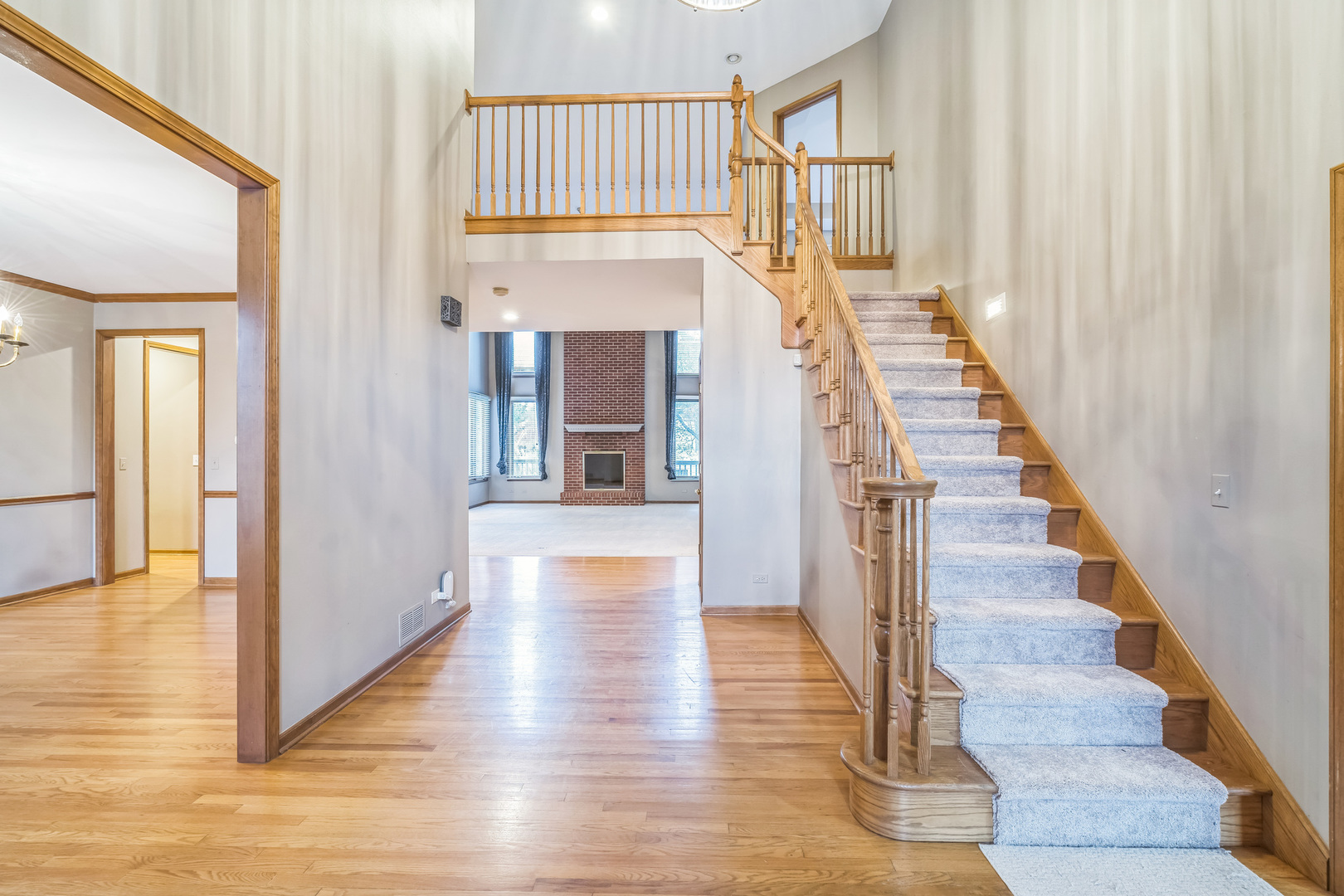 2604 Wendy Road Naperville, IL 60565 - Photo 8 of 62 a view of a hallway with wooden floor and staircase