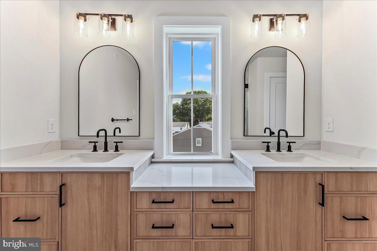 738 South Matlack Street West Chester, PA 19382 - Photo 14 of 23 a bathroom with a granite countertop sink and a mirror