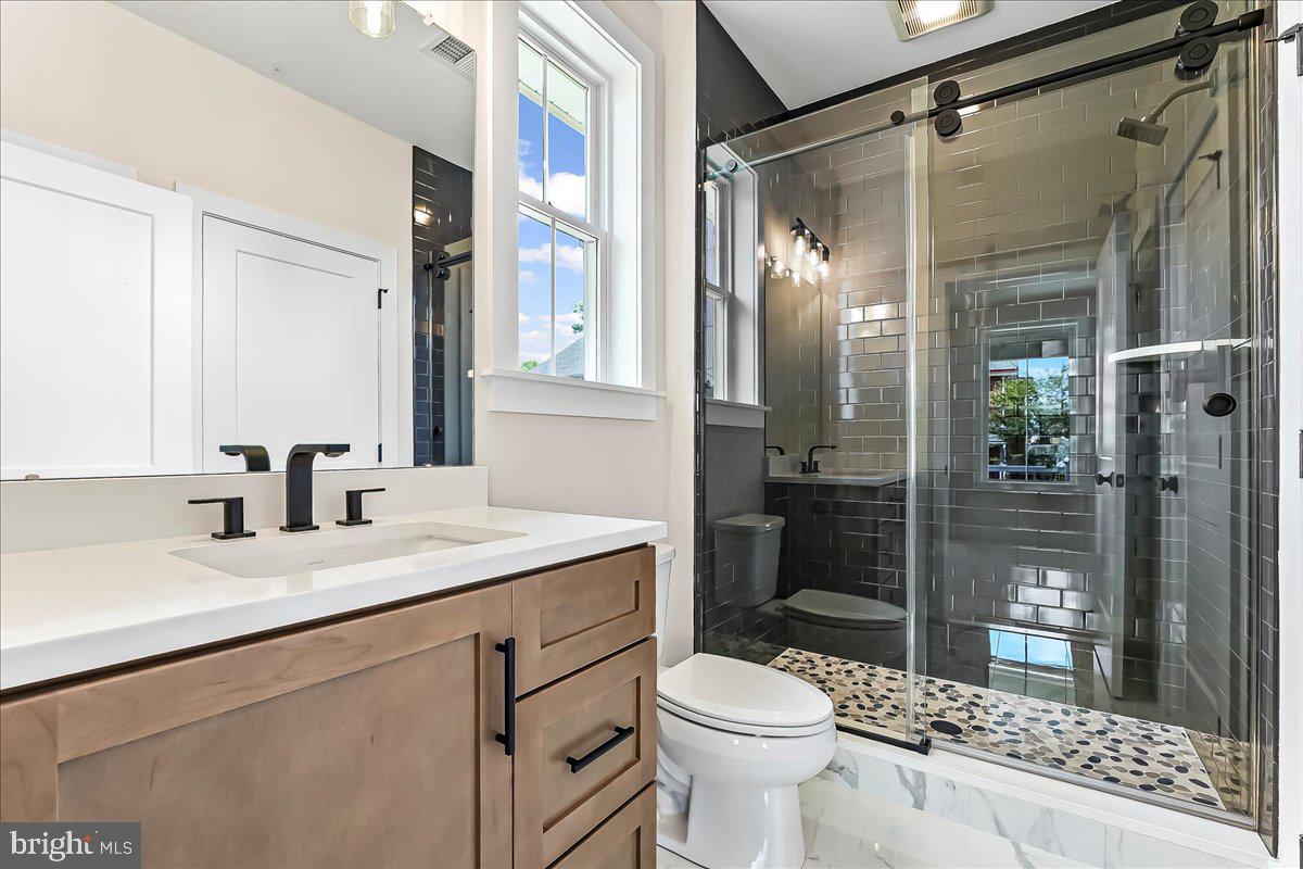 738 South Matlack Street West Chester, PA 19382 - Photo 19 of 23 a bathroom with a granite countertop sink toilet and shower