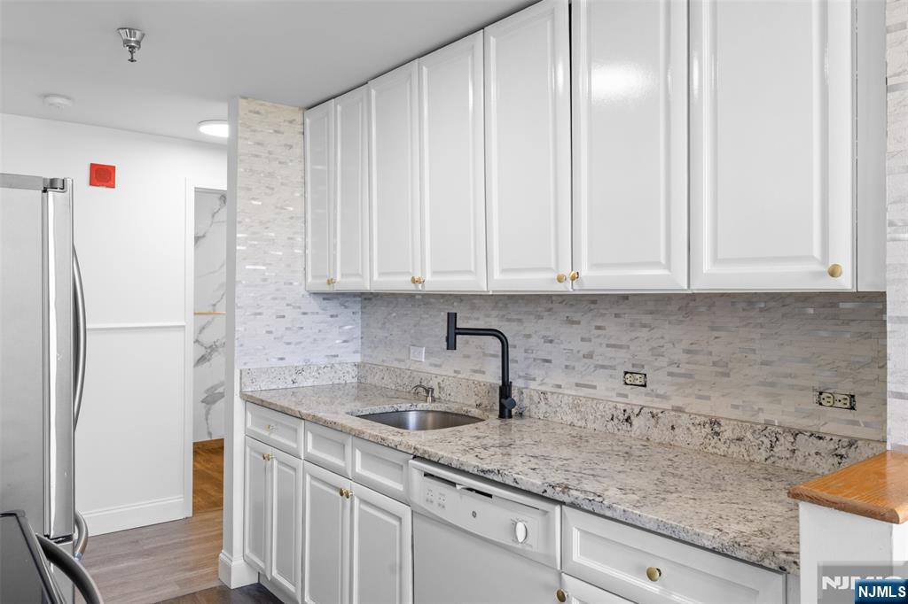 100 Old Palisade Road, Unit 3215 Fort Lee, NJ 07024 - Photo 14 of 43 a kitchen with stainless steel appliances granite countertop white cabinets and a refrigerator