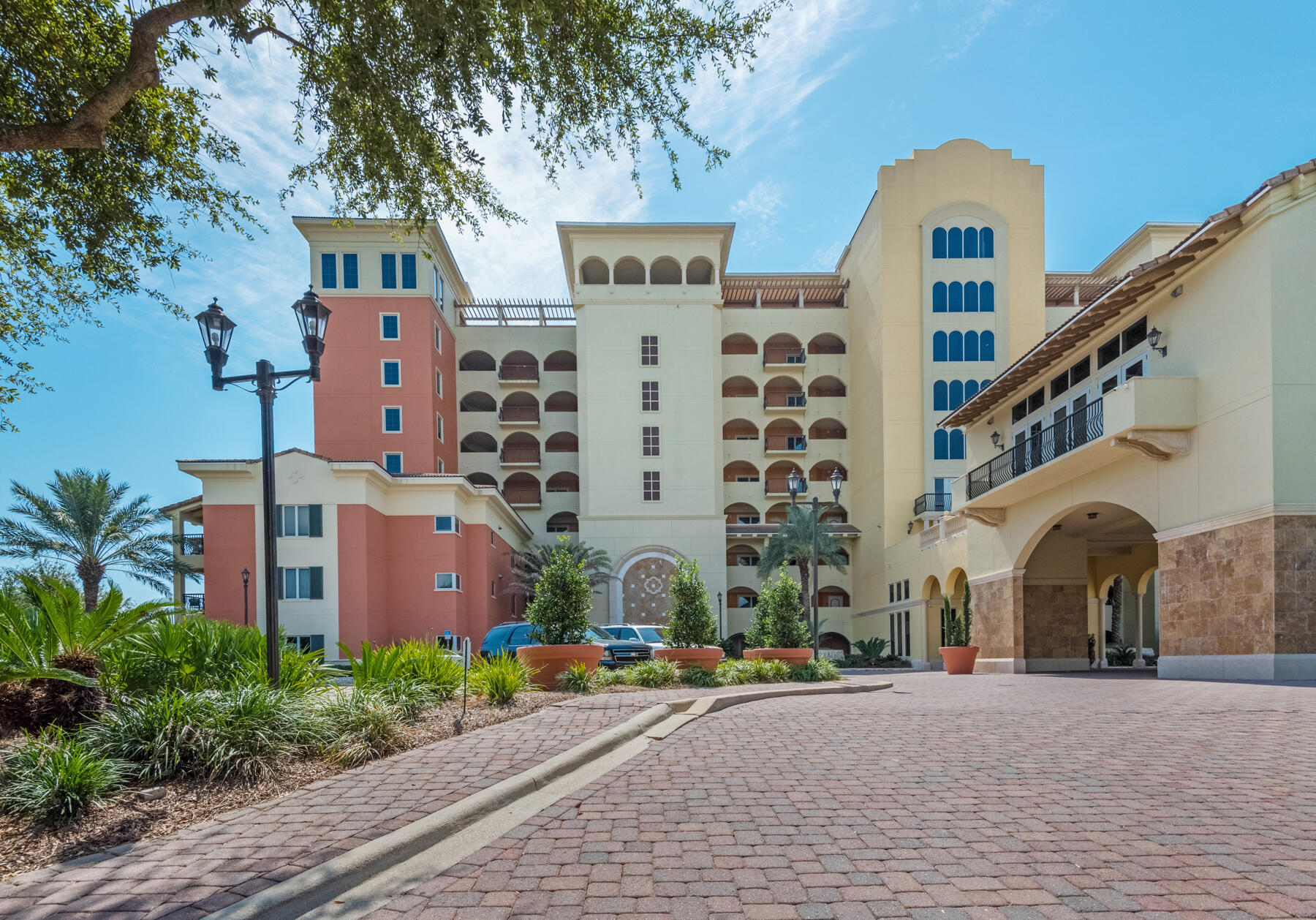 770 Harbor Boulevard, Unit 3E Destin, FL 32541 - Photo 37 of 44 a front view of multi story residential apartment building with yard and potted plants