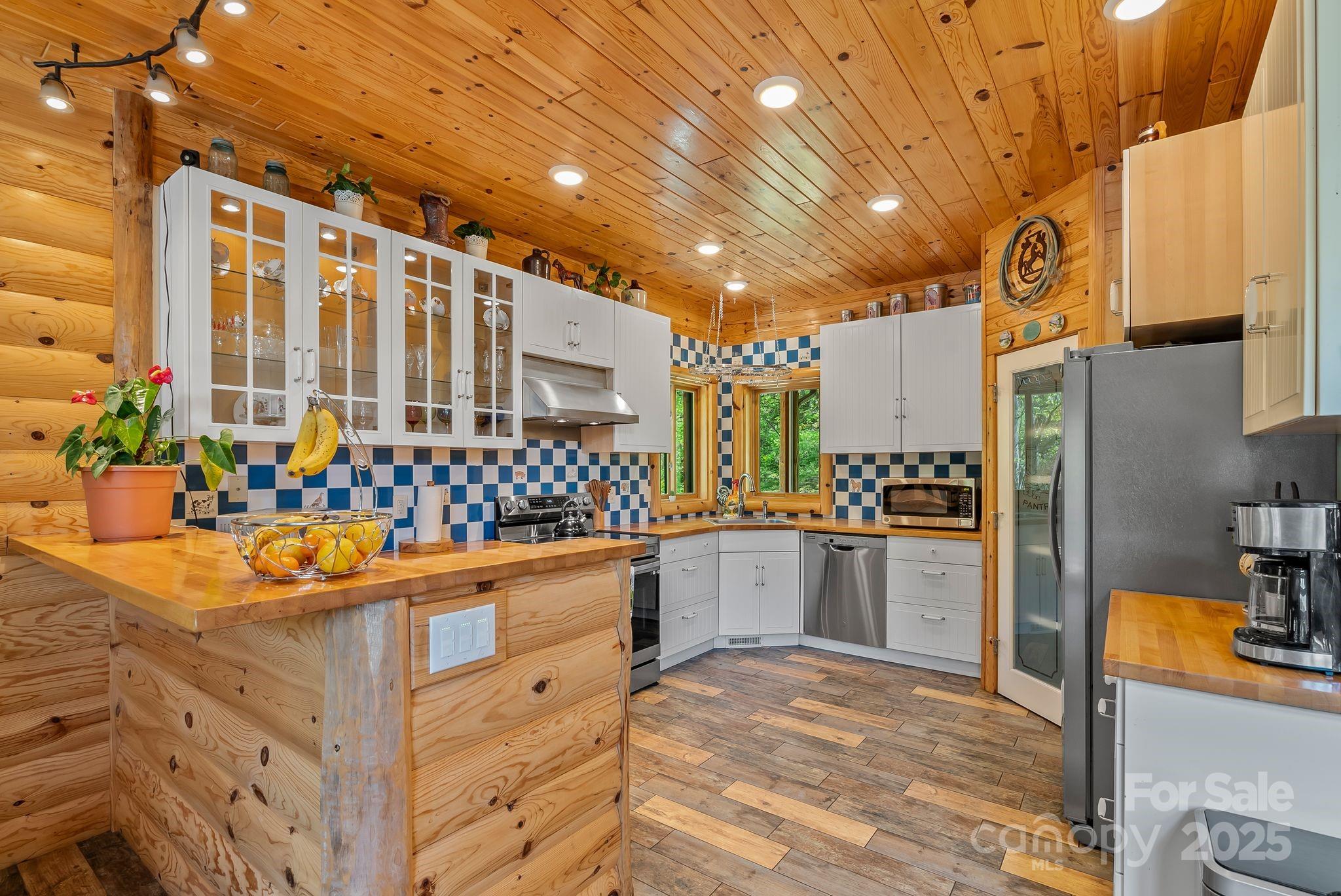 1104 Long Br Road Marshall, NC 28753 - Photo 13 of 45 a view of a kitchen with stainless steel appliances granite countertop cabinets and outdoor space