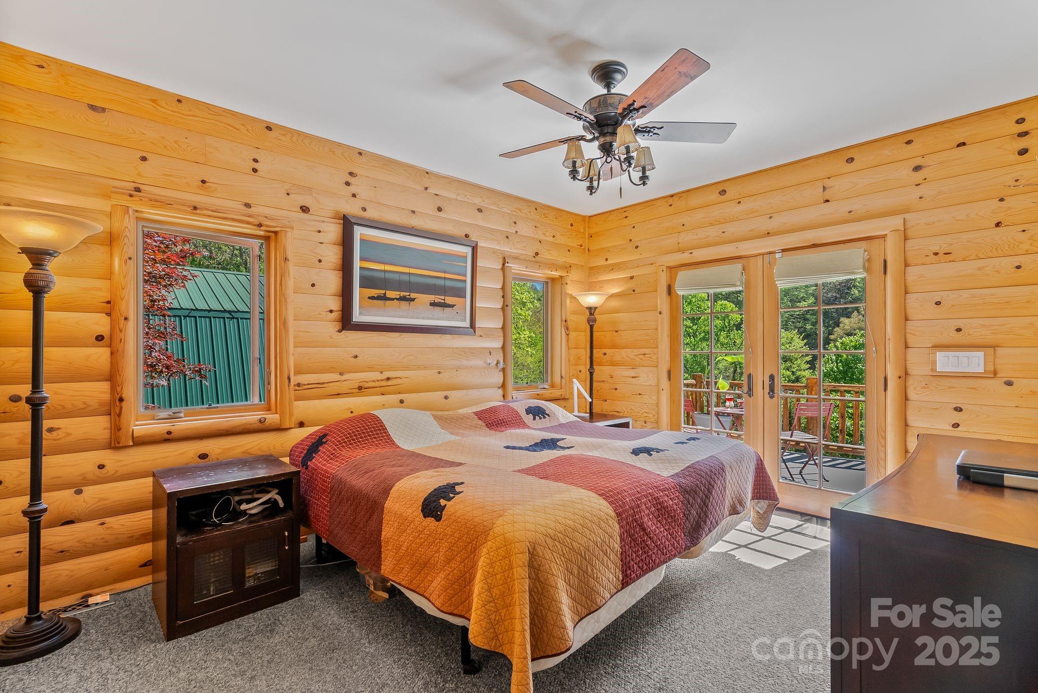 1104 Long Br Road Marshall, NC 28753 - Photo 20 of 45 a bed room with a bed and a chandelier