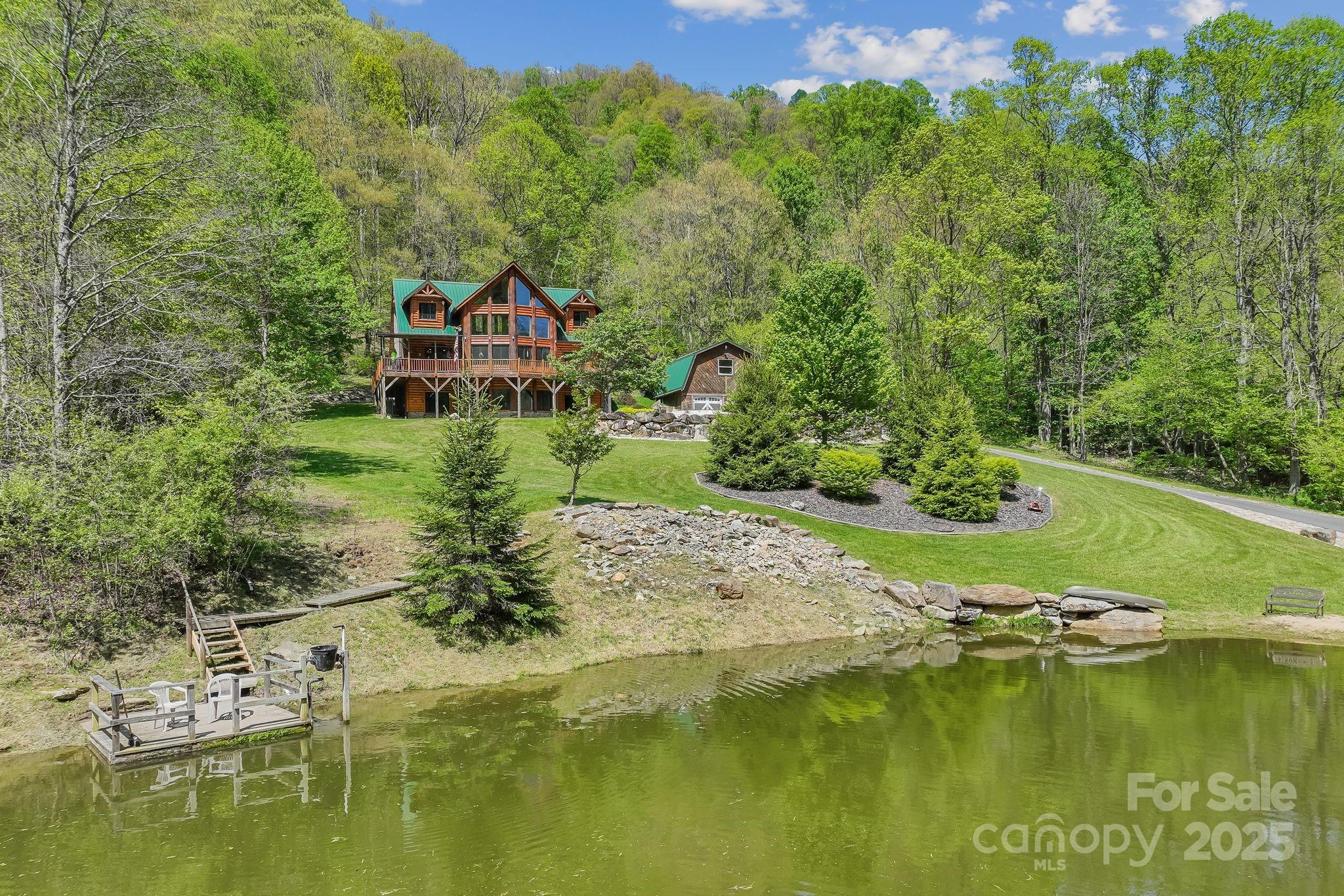 1104 Long Br Road Marshall, NC 28753 - Photo 4 of 45 a view of a lake with a house in the background