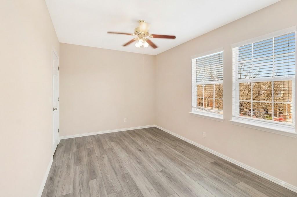 4908 Rushden Road McKinney, TX 75070 - Photo 28 of 34 Room featuring wood-finish flooring, two windows with blinds, and a ceiling fan with integrated lighting