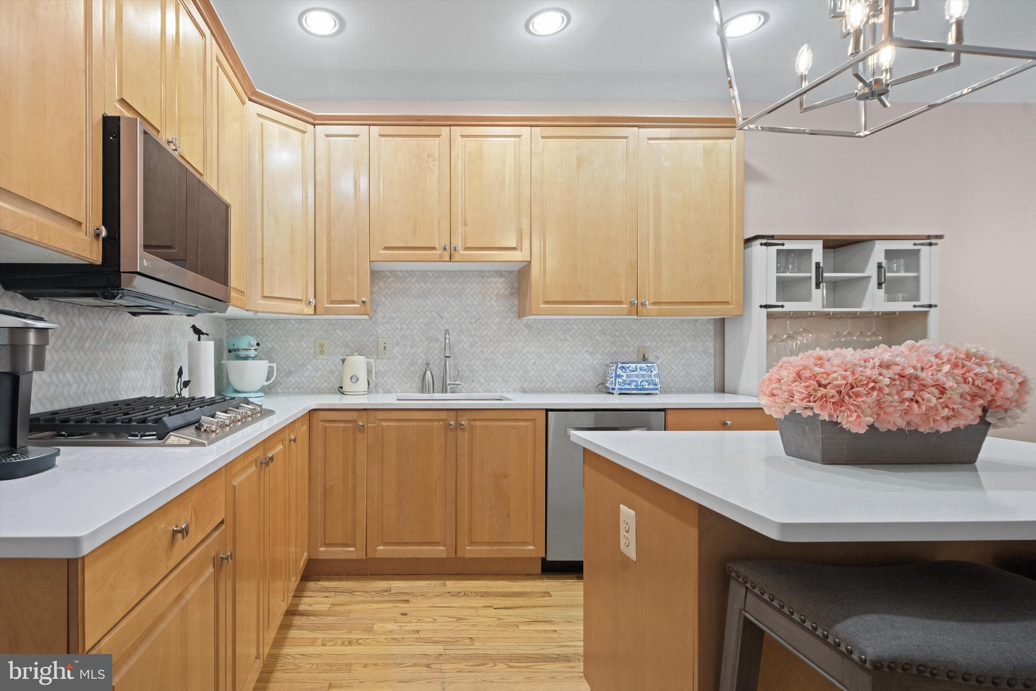 1149 Brian's Way Wayne, PA 19087 - Photo 12 of 37 a kitchen with stainless steel appliances a sink a stove top oven a counter space and cabinets