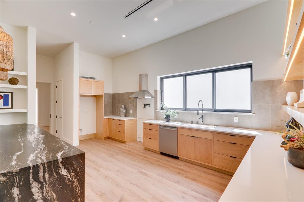 823 West Danieldale Road Duncanville, TX 75137 - Photo 7 of 36 a large kitchen with a lot of counter space and wooden floor