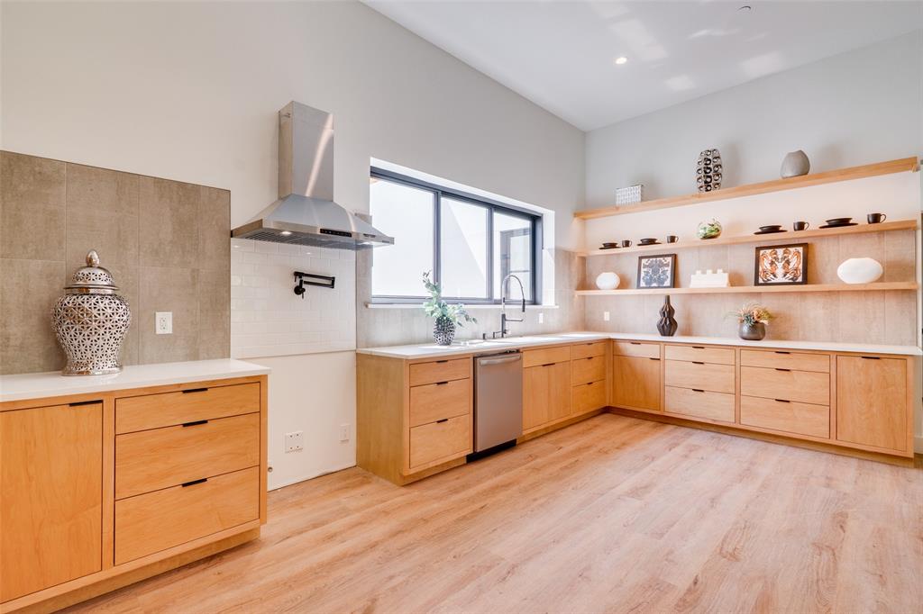 823 West Danieldale Road Duncanville, TX 75137 - Photo 8 of 36 a large kitchen with a white stove top oven a sink and dishwasher with wooden floor