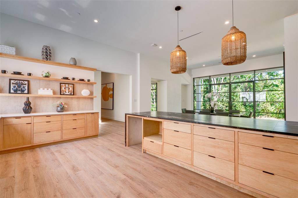 823 West Danieldale Road Duncanville, TX 75137 - Photo 9 of 36 a large kitchen with kitchen island granite countertop a stove a sink and a large window with wooden floors
