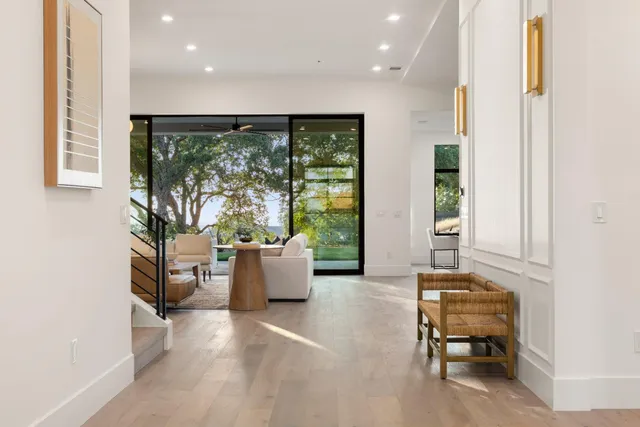 a kitchen with a sink a potted plant and cabinets