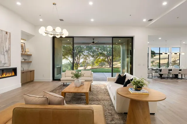 a kitchen with a table chairs sink and cabinets