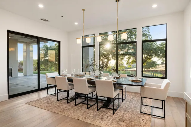 a large kitchen with stainless steel appliances and a large window