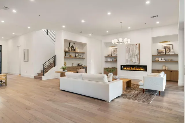 a large kitchen with stainless steel appliances kitchen island granite countertop a large cabinets a sink and a counter top space