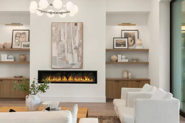 a living room with furniture a chandelier and a flat screen tv