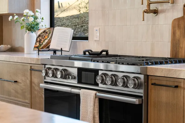 a bathroom with a tub a window and a shower