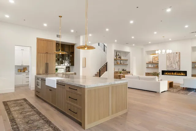 a living room with furniture a table tennis table and wooden floor