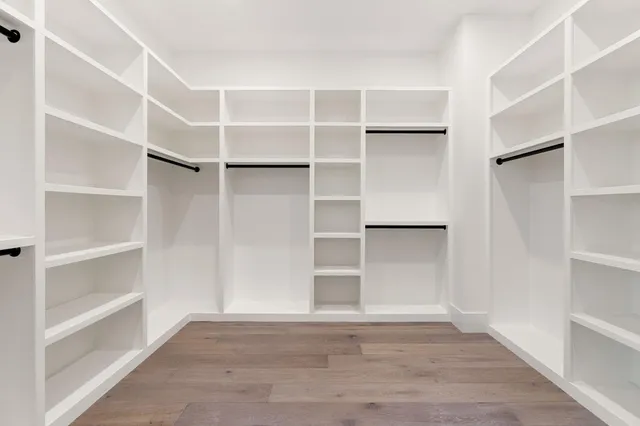 a view of an empty room with a fireplace and a large window