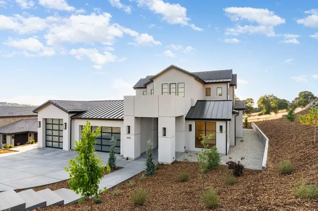 a living room with furniture a chandelier and a fireplace