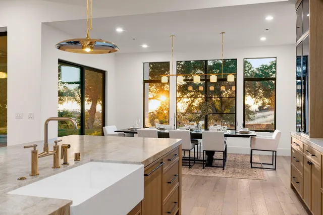 a view of a dining room with furniture large windows and wooden floor